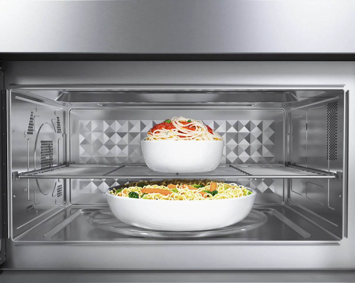 Bosch HMV8054U over-the-range microwave open with food inside