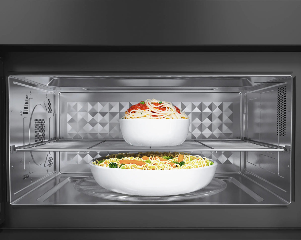 Bosch HMV8045U over-the-range microwave open with dish inside