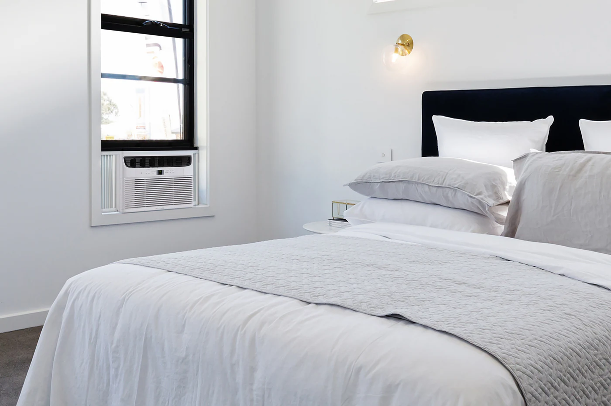 Frigidaire 12000 BTU window air conditioner installed on a bedroom window