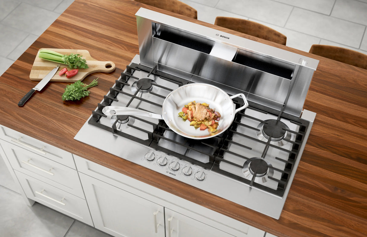 Bosch NGM8659UC gas cooktop in counter with food