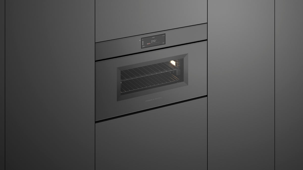 Fisher & Paykel OS30NMUNG3 Minimal Handleless Compact Combi-Steam Oven installed in kitchen, lights on