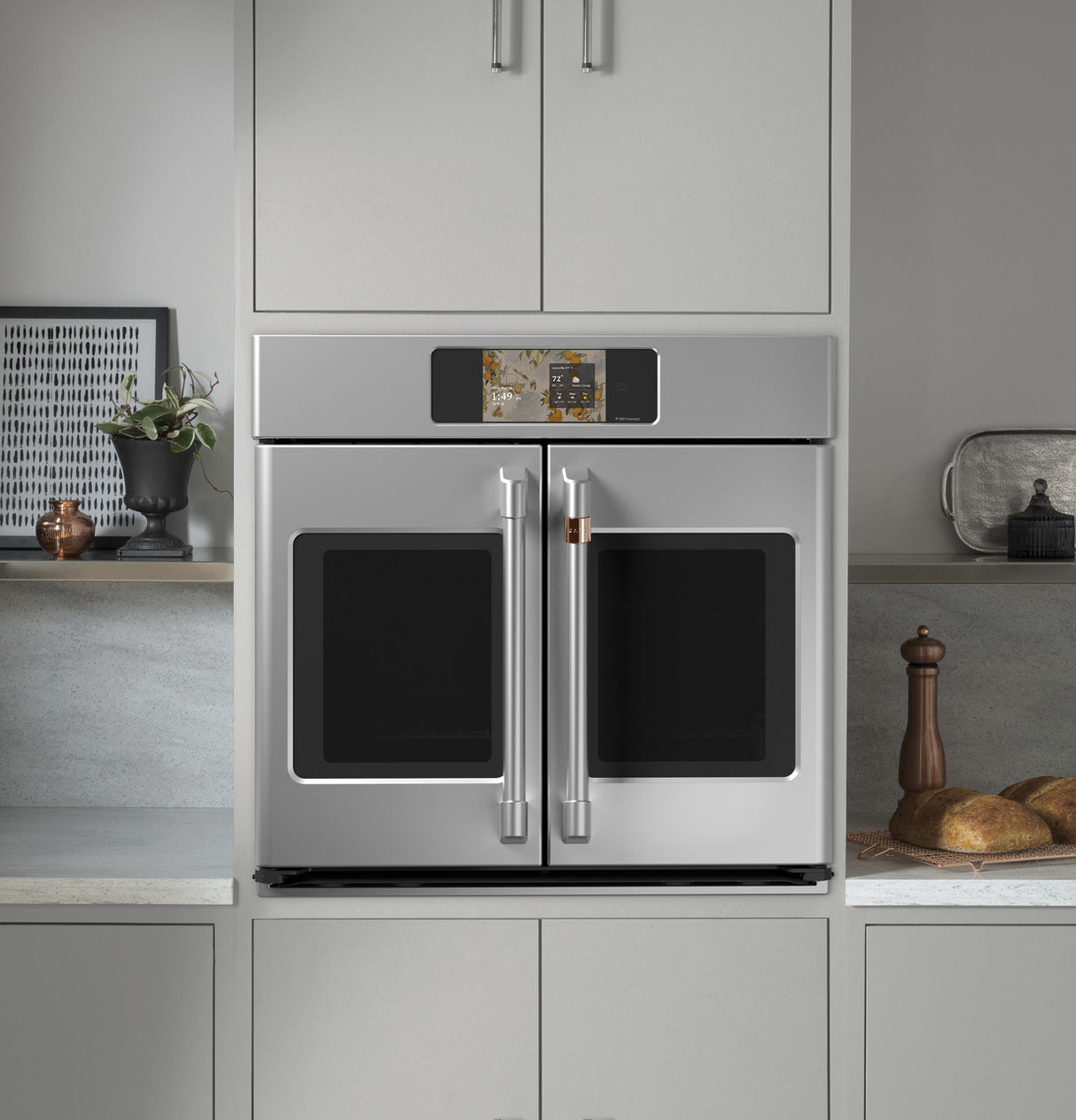 Café CTS90FP2ZS1 French-door wall oven with doors open showing oven interior