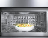Bosch HMV8054U over-the-range microwave interior with food