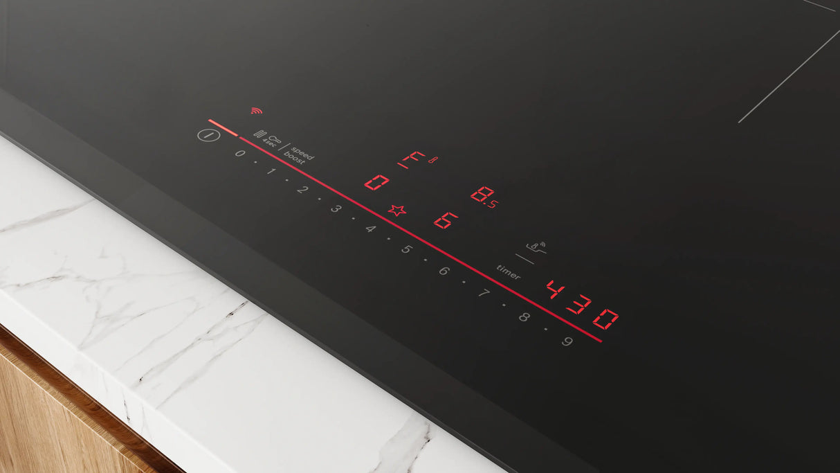 Bosch NIT8061UC induction cooktop in use with cookware
