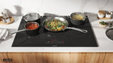 Bosch NET8062UC electric cooktop in use with cookware