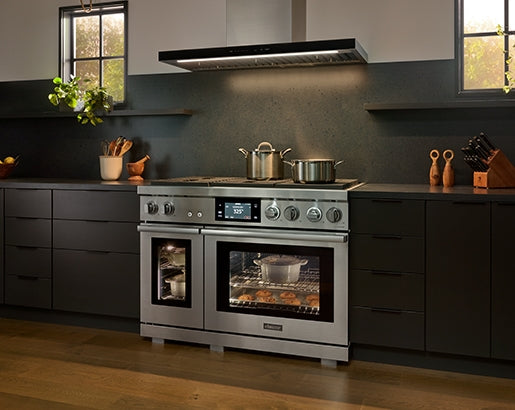 Dacor DHD48U990WM chimney wall hood above range lifestyle view