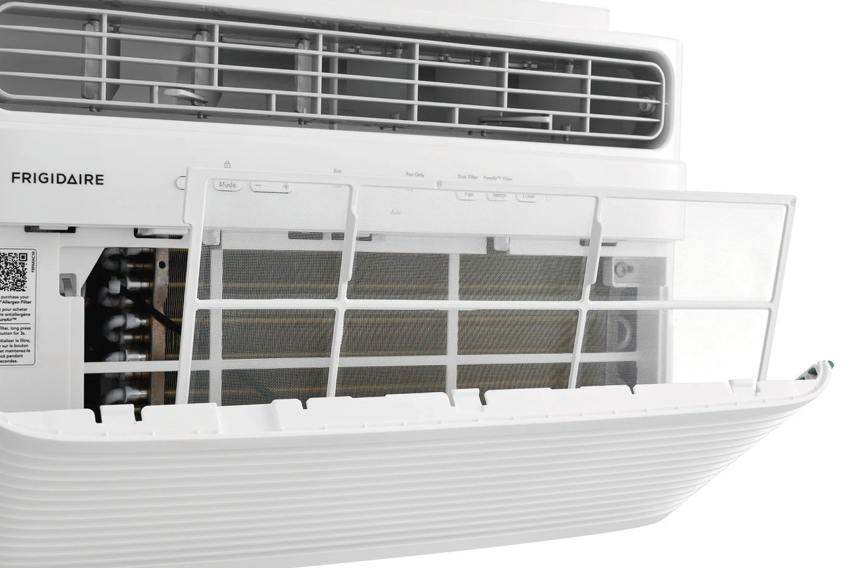 Close-up view of a Frigidaire FHWC064TE1 6,000 BTU Window Air Conditioner, with the front panel open to reveal a white, removable mesh air filter. The filter is designed for easy cleaning and maintenance of the AC unit.