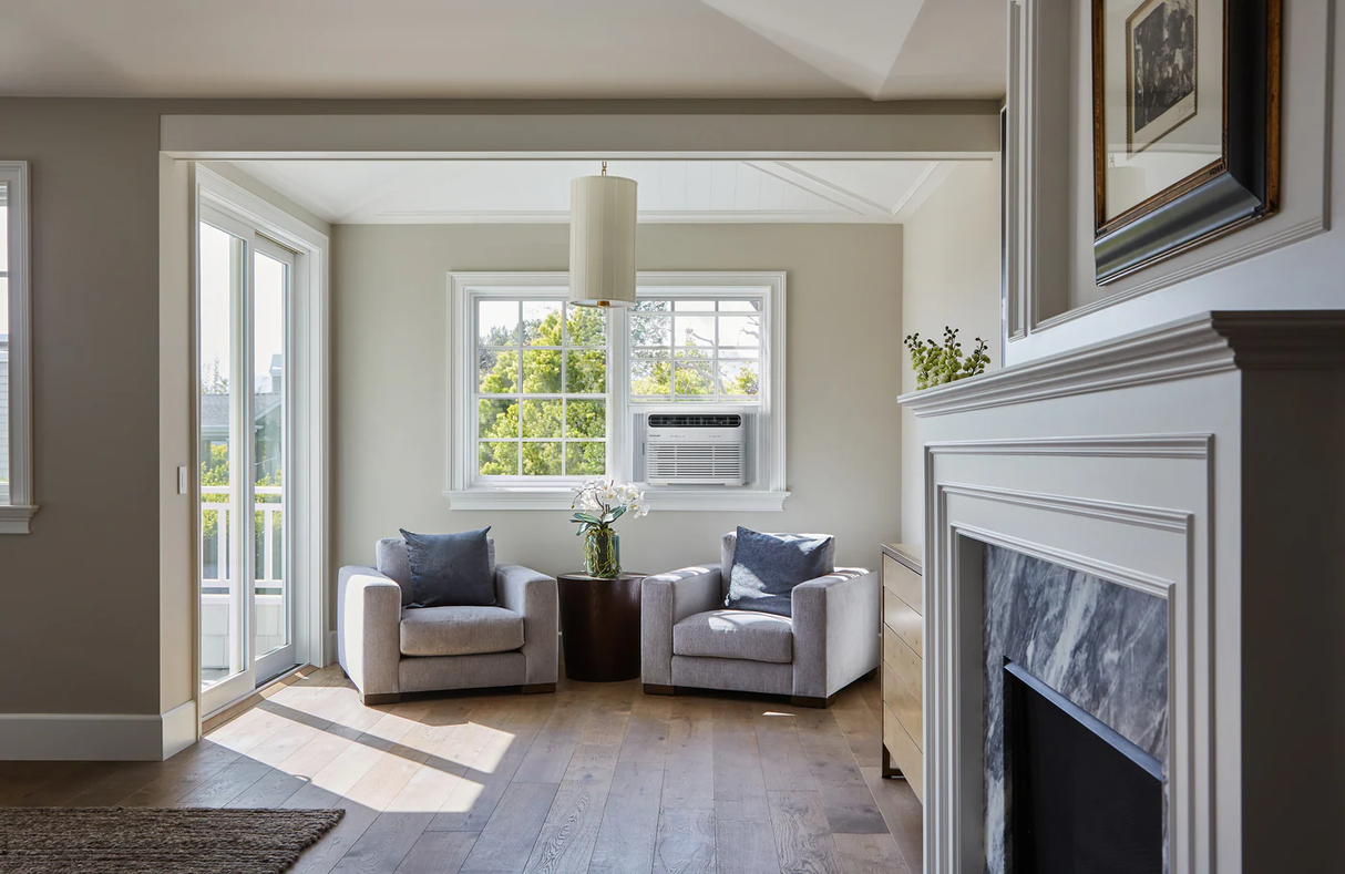 A Frigidaire 12,000 BTU Window Room Air Conditioner with Wi-Fi unit mounted on a living room window