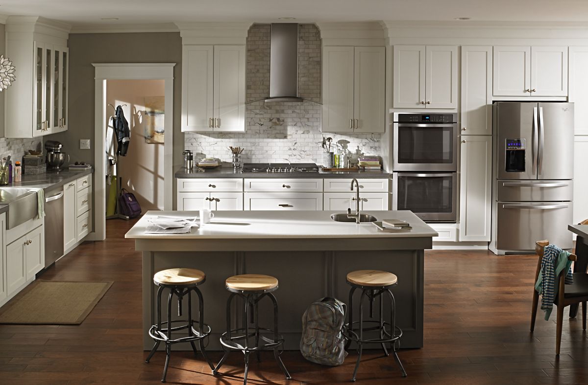Whirlpool WVI75UC6DS island range hood installed over a kitchen island