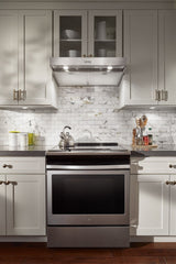 Whirlpool WVU37UC6FS range hood installed above a range