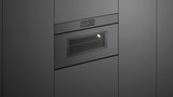 Fisher & Paykel OS30NMUNG3 Minimal Handleless Compact Combi-Steam Oven installed in kitchen, lights on