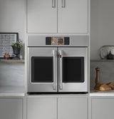 Café CTS90FP2ZS1 French-door wall oven with doors open showing oven interior