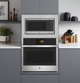 GE Profile PCWK22U1WSS microwave with trim kit over wall oven