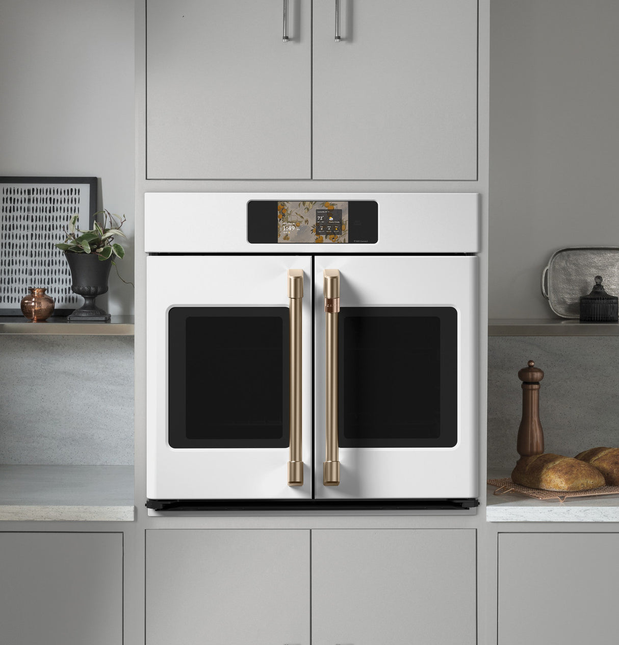 Café CTS90FP4ZW2 French-door wall oven with doors open showing oven interior