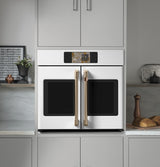 Café CTS90FP4ZW2 French-door wall oven with doors open showing oven interior