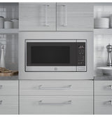GE Profile PCWK22U1WSS microwave installed in a kitchen cabinet